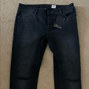 Distressed black ripped knee jeans